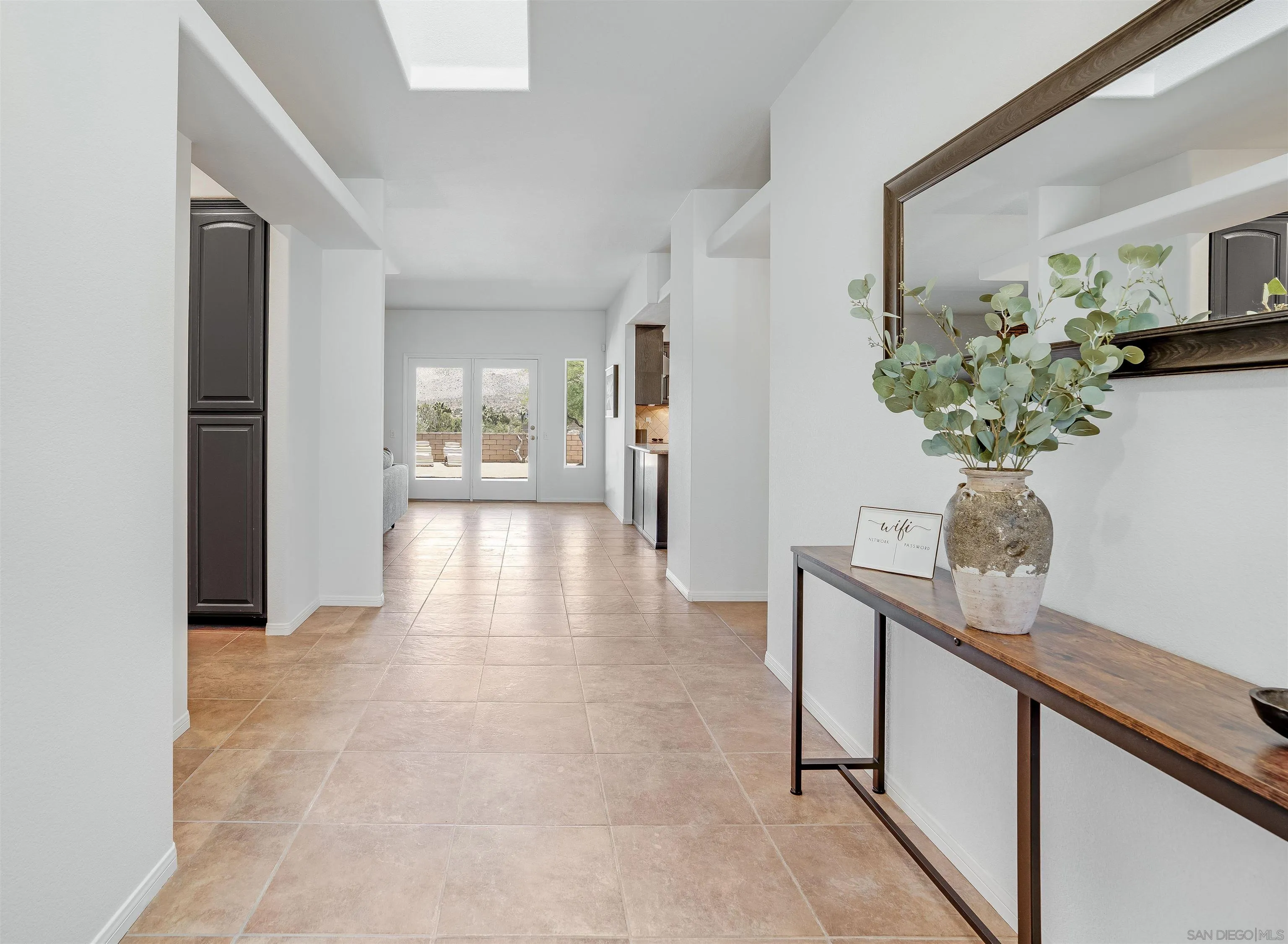 9255 Del Monte Avenue Yucca Valley, CA 92284 - Photo 4 of 46 a hallway with painting and a potted plant