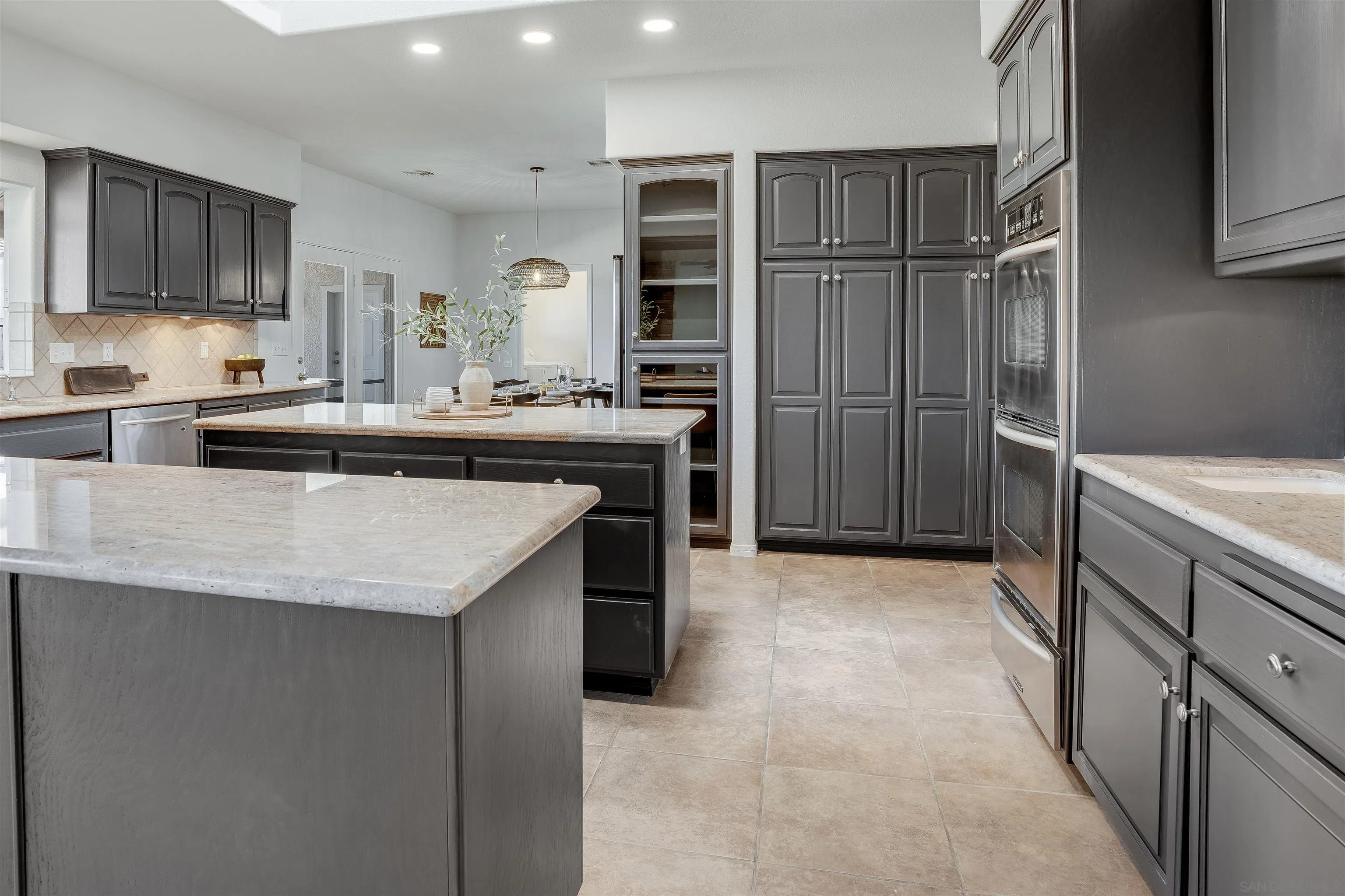 9255 Del Monte Avenue Yucca Valley, CA 92284 - Photo 7 of 46 a kitchen with kitchen island granite countertop a sink stove and refrigerator