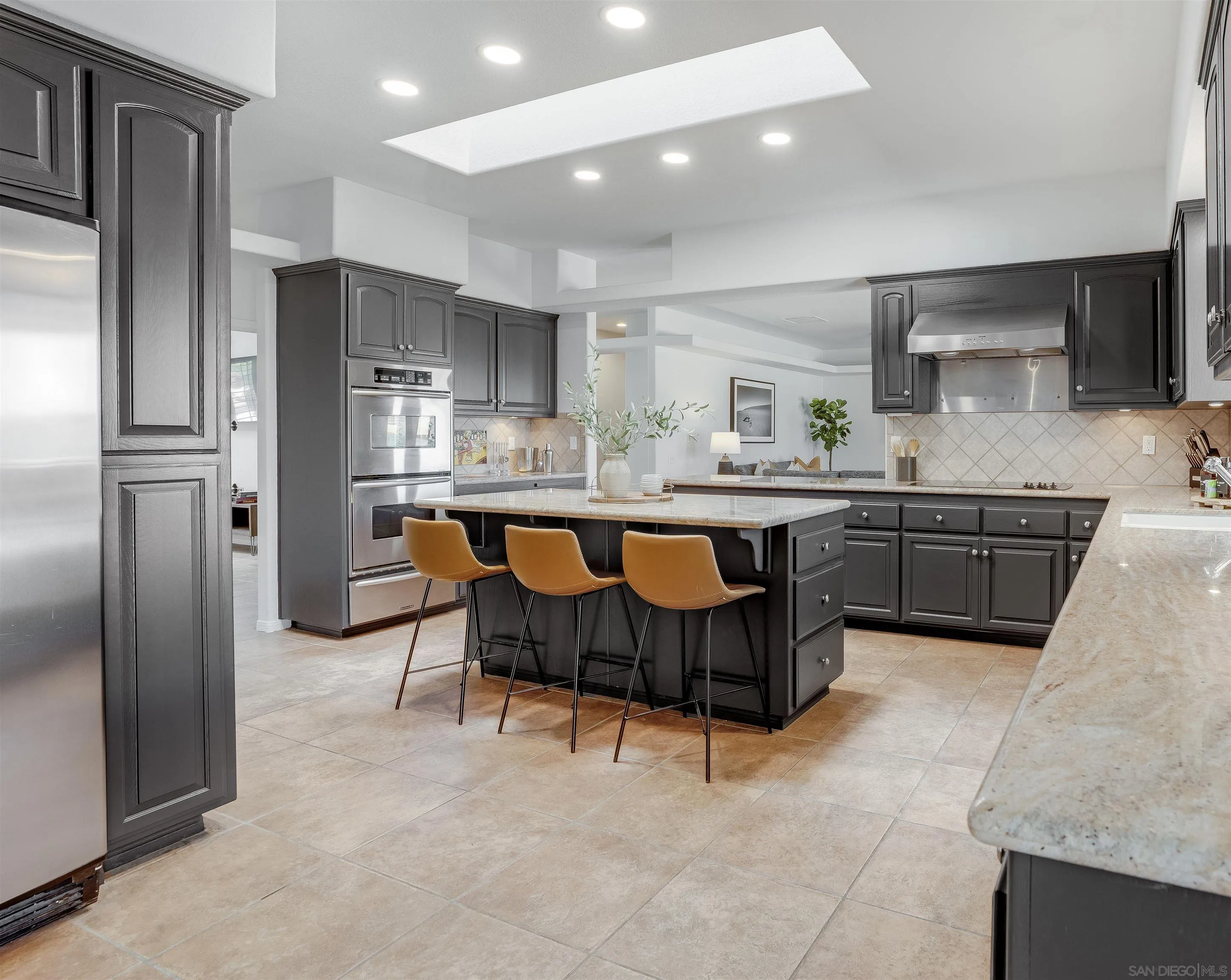 9255 Del Monte Avenue Yucca Valley, CA 92284 - Photo 8 of 46 a kitchen with stainless steel appliances granite countertop a table chairs sink refrigerator and cabinets