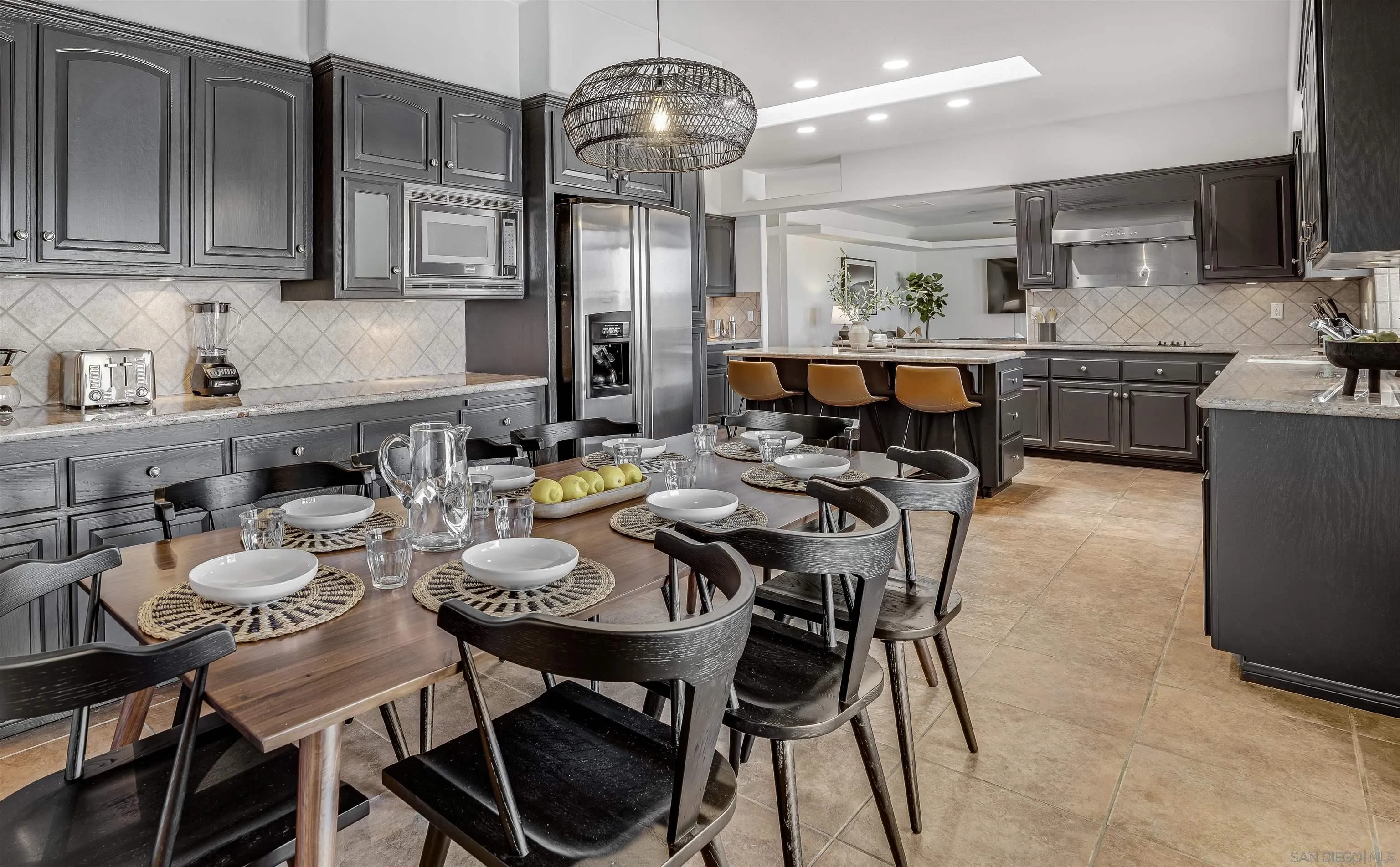 9255 Del Monte Avenue Yucca Valley, CA 92284 - Photo 10 of 46 a kitchen with a dining table chairs and microwave