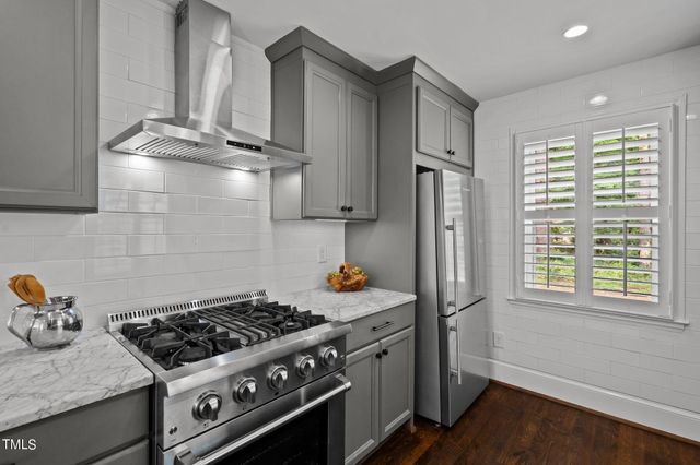a kitchen with stainless steel appliances a stove a sink and a refrigerator