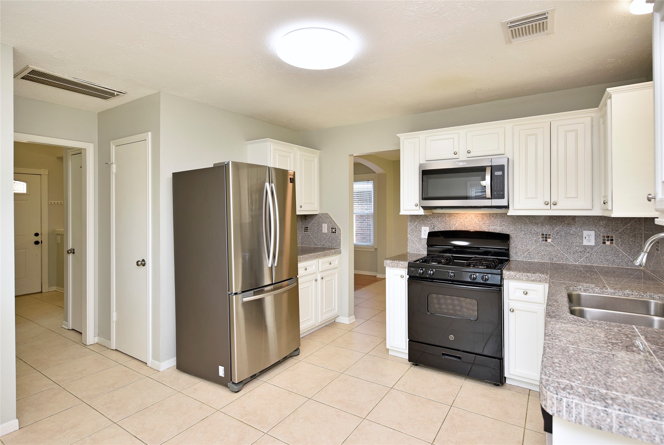 31106 Pine Bay Street Spring, TX 77386 - Photo 11 of 38 a kitchen with stainless steel appliances granite countertop a refrigerator stove and sink