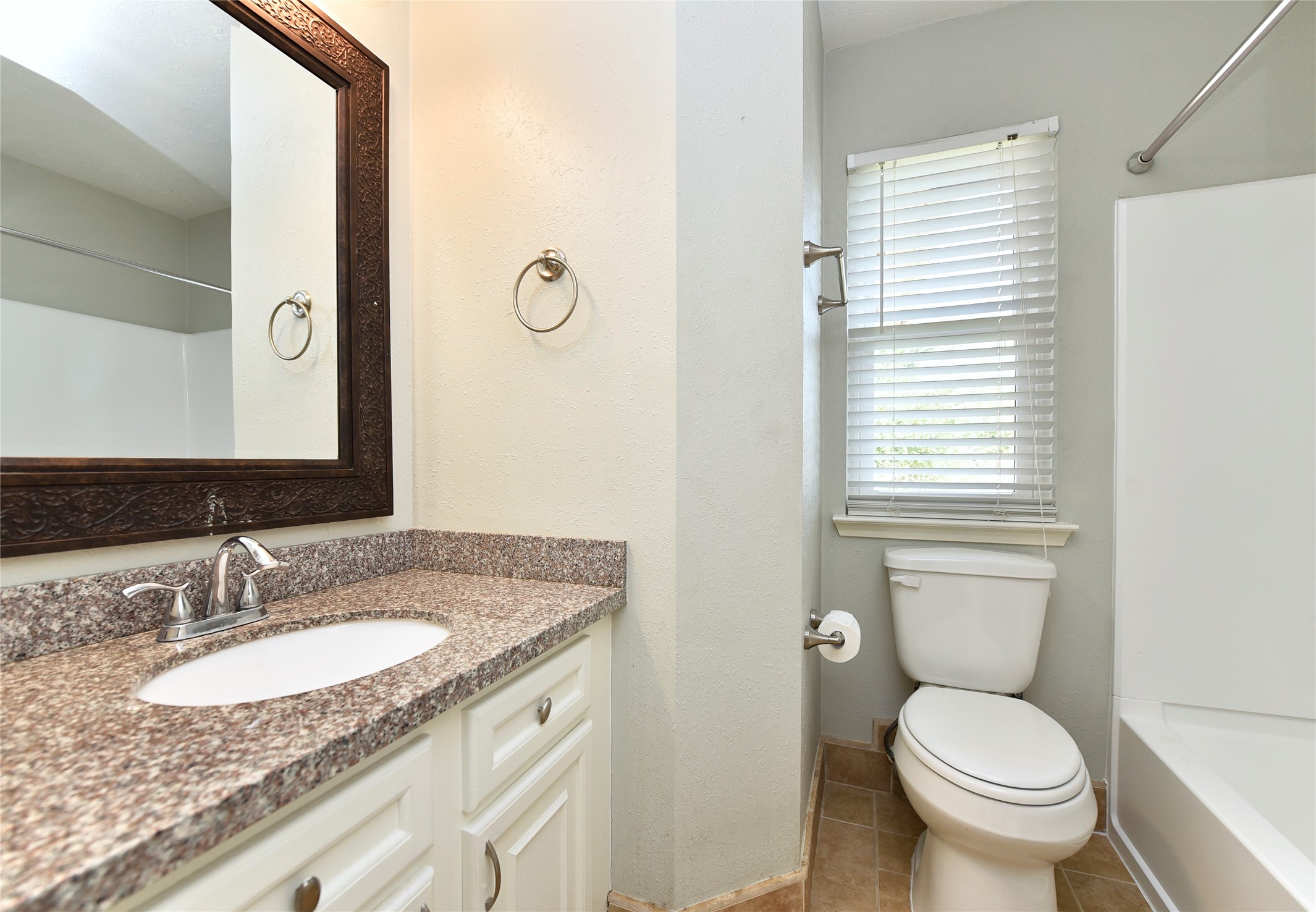 31106 Pine Bay Street Spring, TX 77386 - Photo 29 of 38 a bathroom with a granite countertop toilet sink and mirror