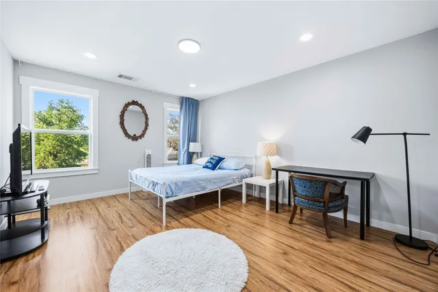 a living room with a couch a rug and a window