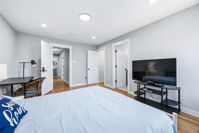 a bedroom with a bed and a flat screen tv