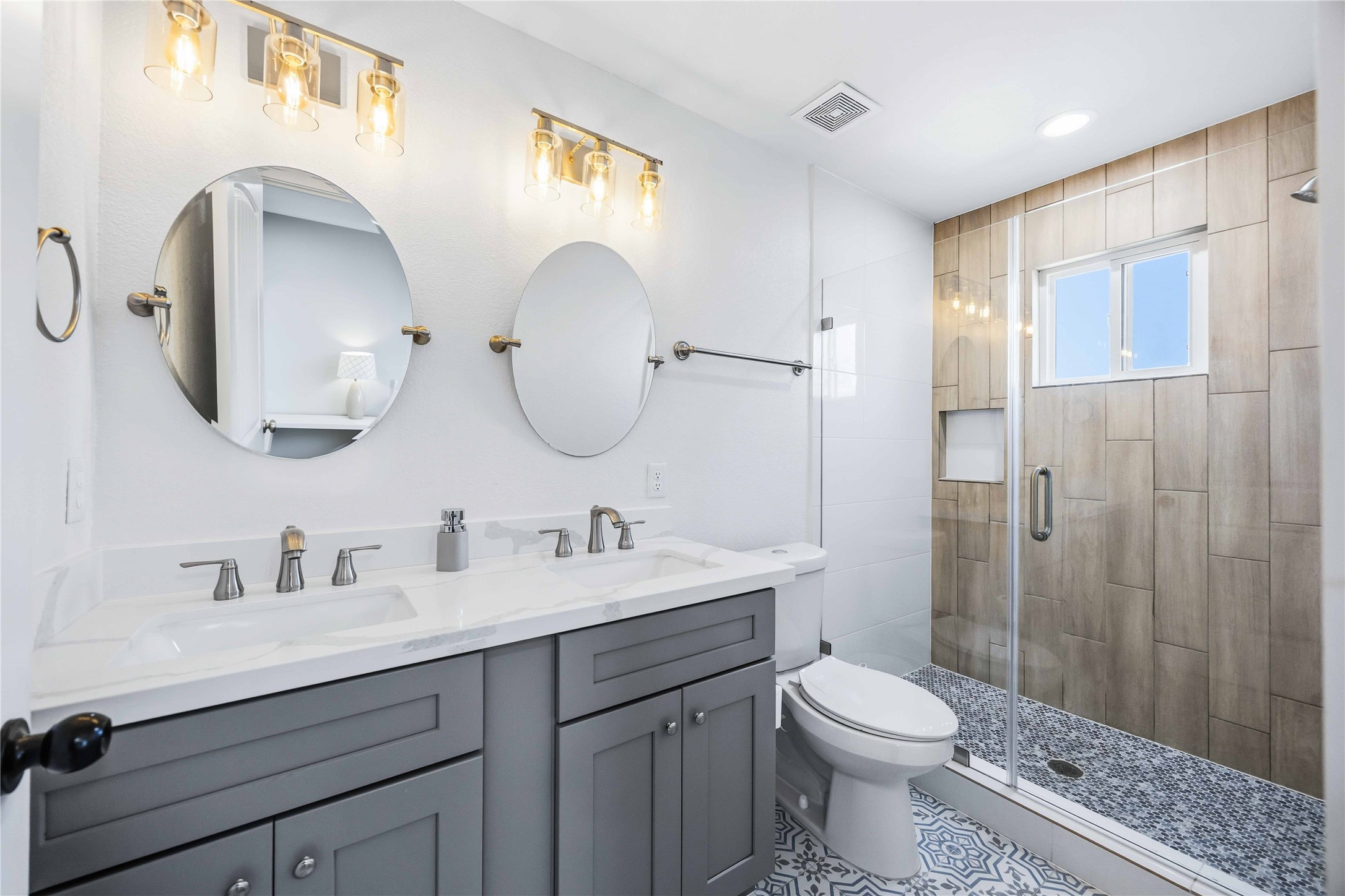 5403 Amy Street Houston, TX 77028 - Photo 18 of 27 a bathroom with a double vanity sink mirror and toilet