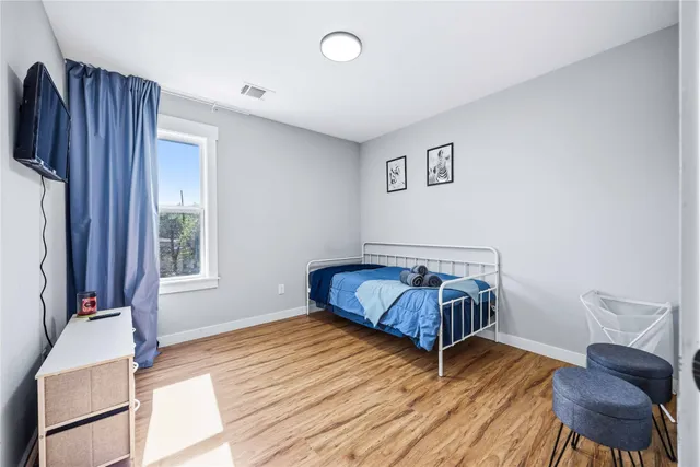 a bedroom with a bed and window