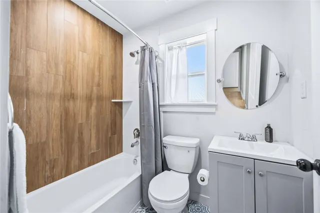 a white toilet sitting next to a bathroom sink