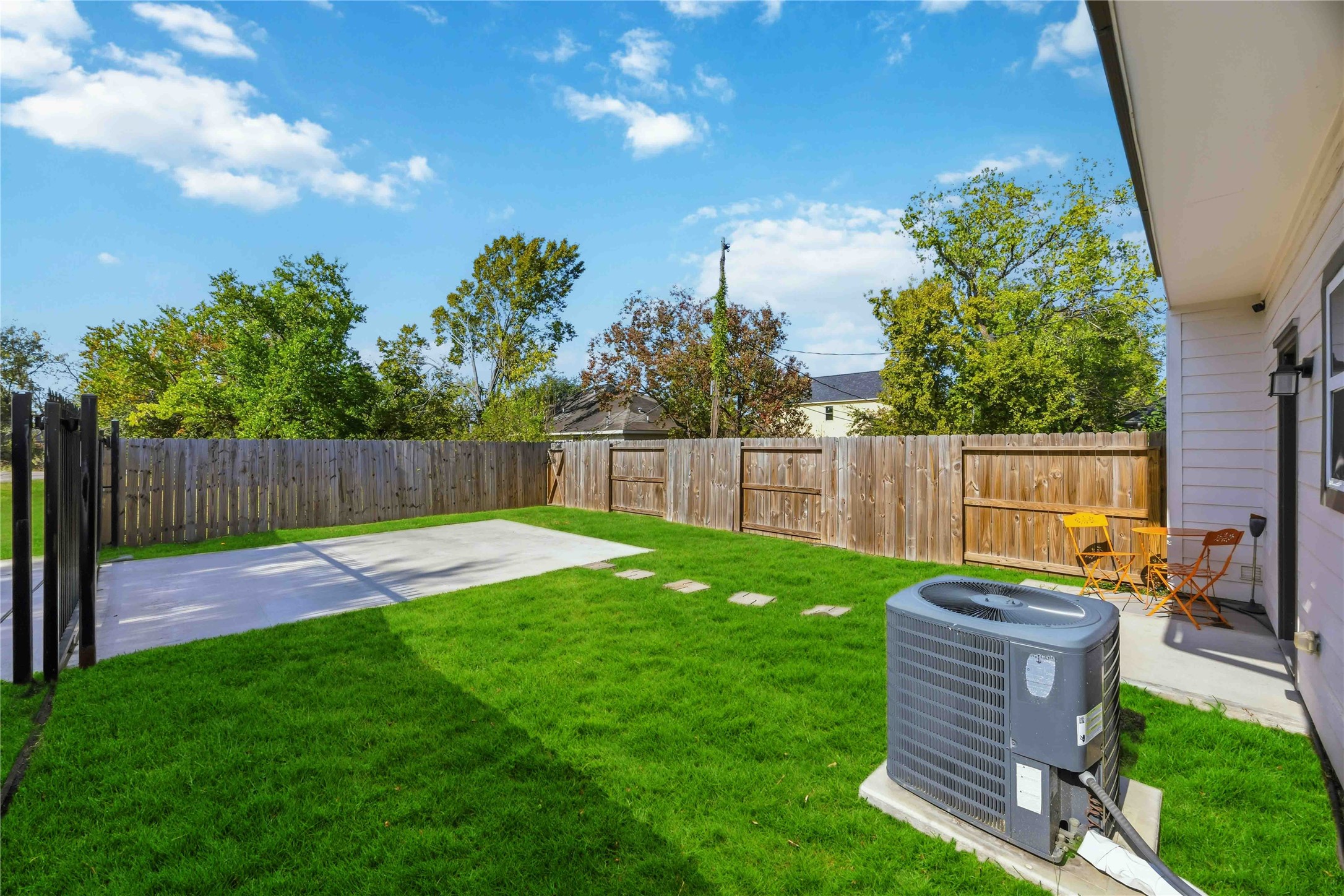 5403 Amy Street Houston, TX 77028 - Photo 25 of 27 a view of a backyard with table and chairs and wooden fence
