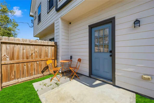 a backyard of a house with table and chairs
