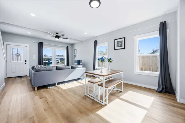 a living room with furniture and a wooden floor