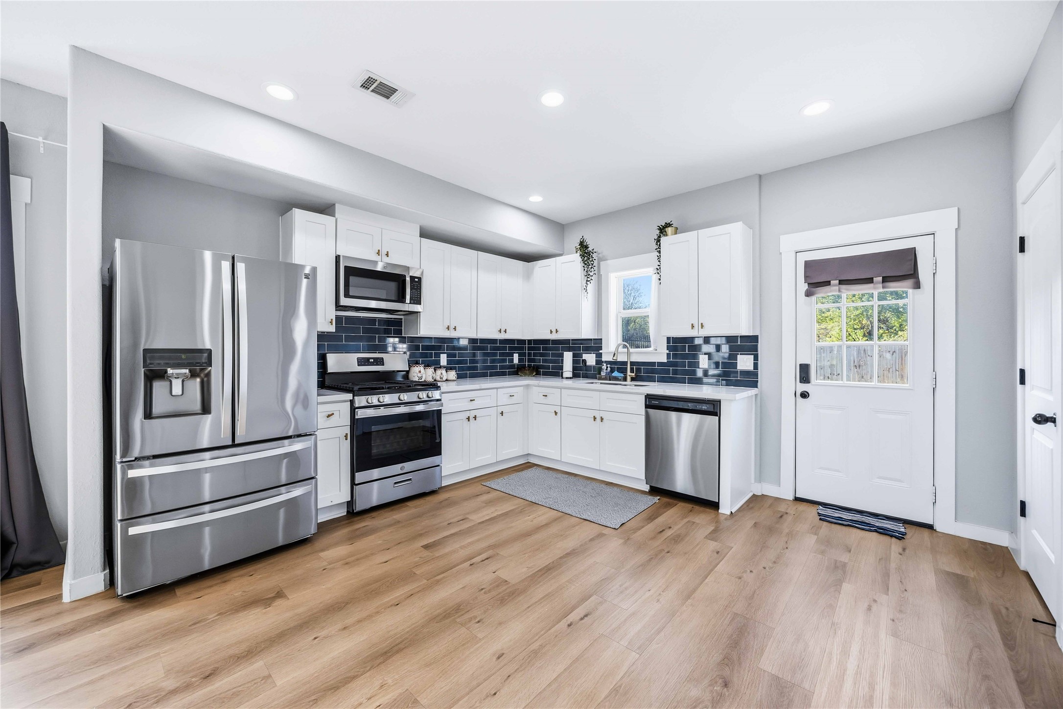 5403 Amy Street Houston, TX 77028 - Photo 10 of 27 a kitchen with a refrigerator and a stove top oven