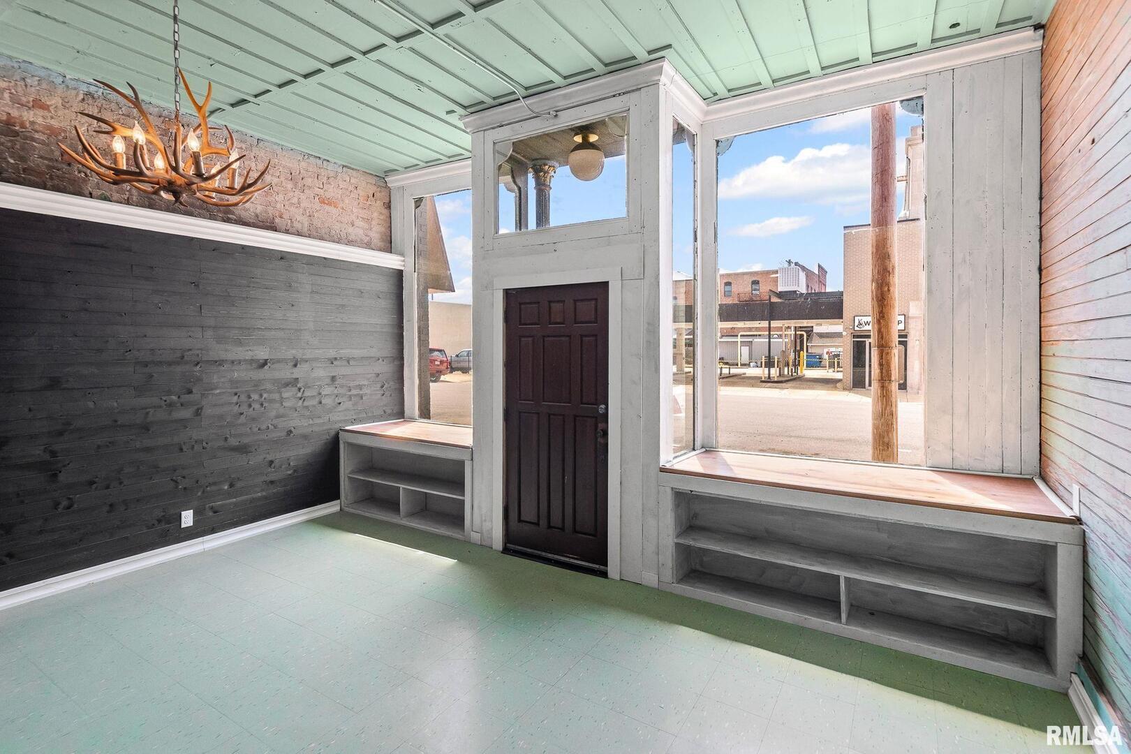 6 South Division Street Du Quoin, IL 62832 - Photo 12 of 47 a view of an empty room with a fireplace and a window