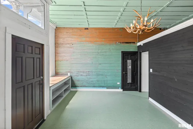 a view of a porch with a door and a chair