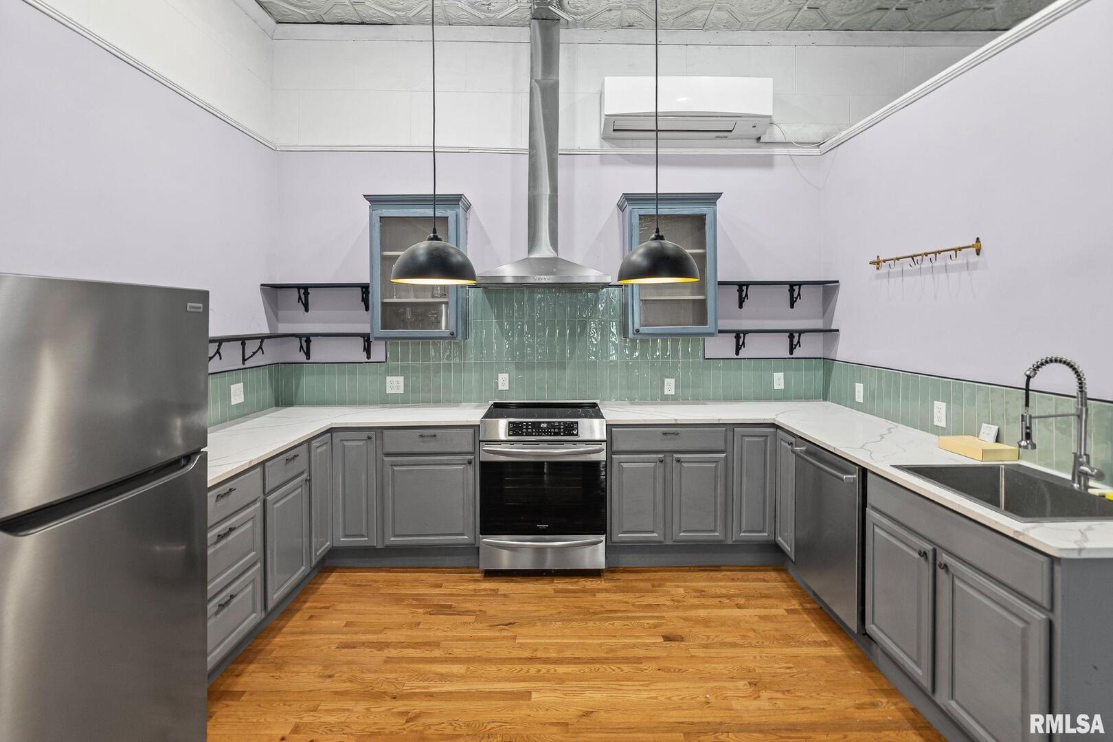 6 South Division Street Du Quoin, IL 62832 - Photo 18 of 47 a kitchen with stainless steel appliances granite countertop a sink stove and refrigerator