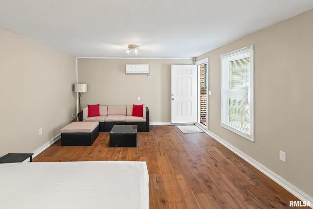 a bed sitting in a bedroom next to a window