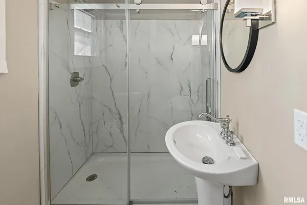 a view of a kitchen with a sink wooden floor and a window