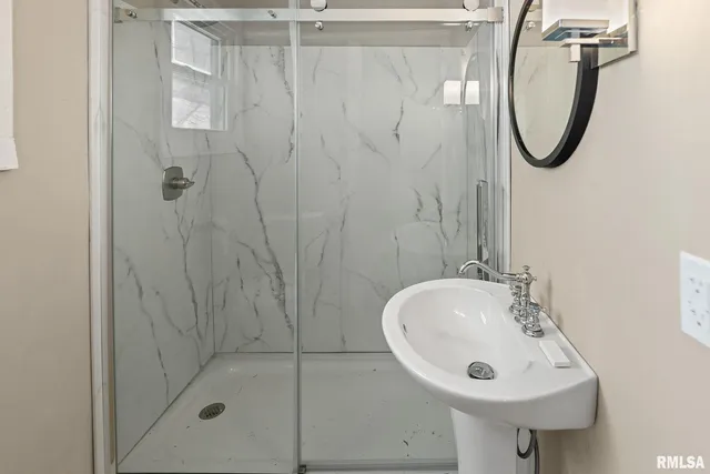 a view of a kitchen with a sink wooden floor and a window