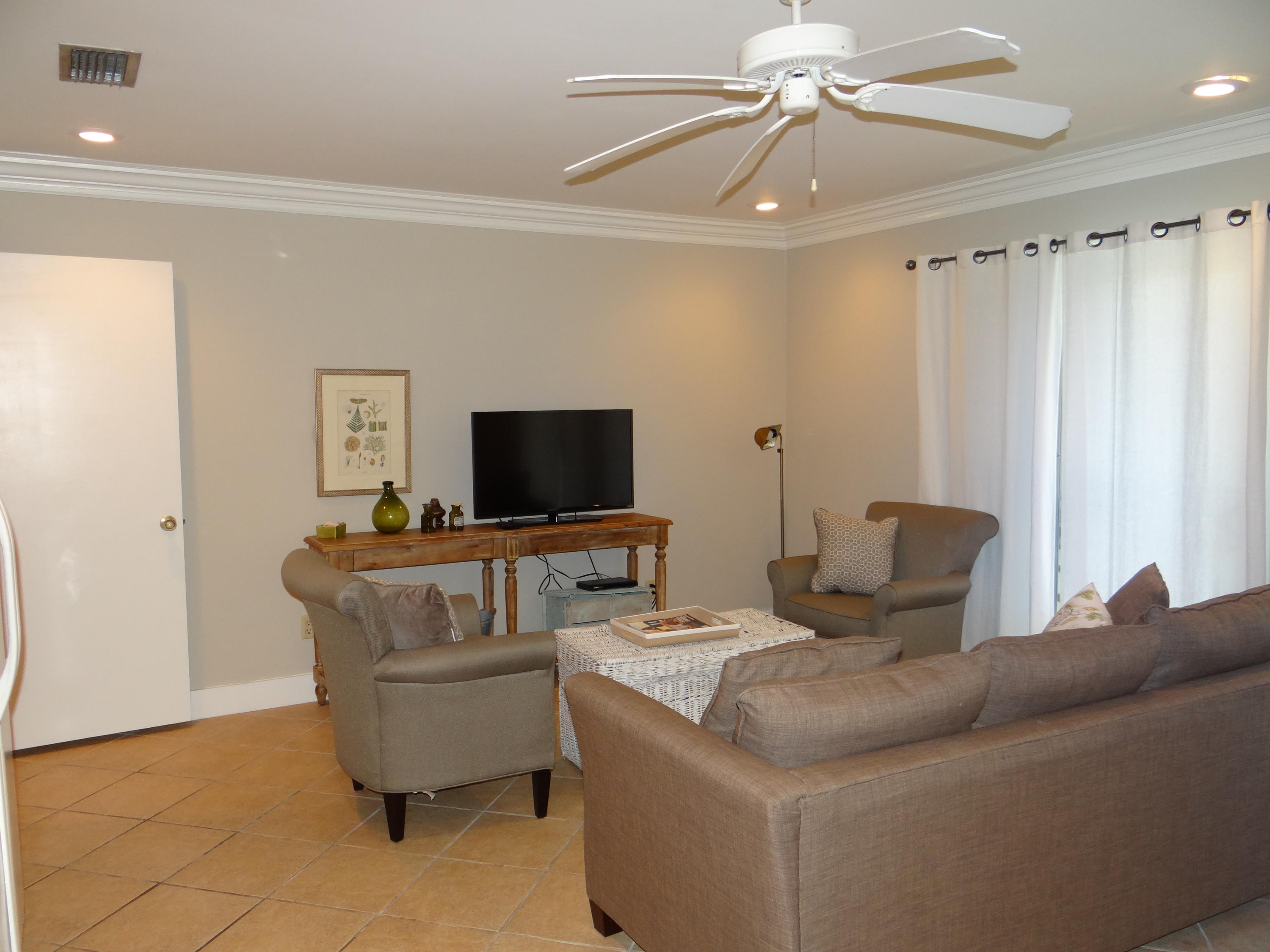 81 South Orange Street, Unit 102 Inlet Beach, FL 32461 - Photo 7 of 14 a living room with furniture and a flat screen tv