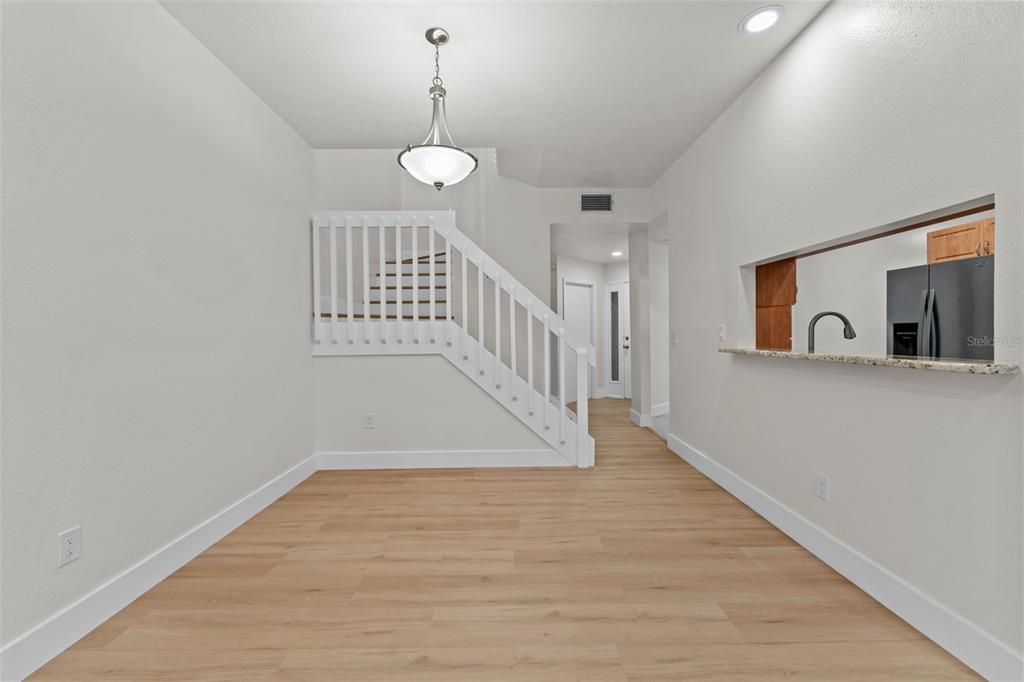 3058 Overlook Place Clearwater, FL 33760 - Photo 16 of 45 a view of a hallway with wooden floor and staircase