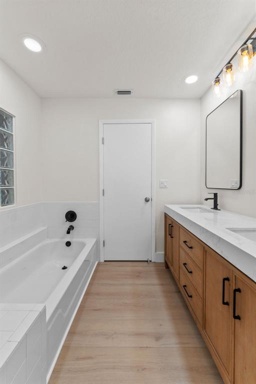 3058 Overlook Place Clearwater, FL 33760 - Photo 21 of 45 a bathroom with a tub sink and mirror