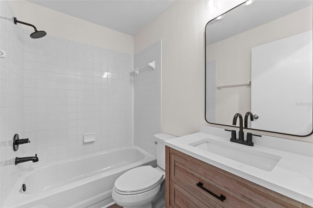 3058 Overlook Place Clearwater, FL 33760 - Photo 29 of 45 a bathroom with a sink a toilet and a bathtub