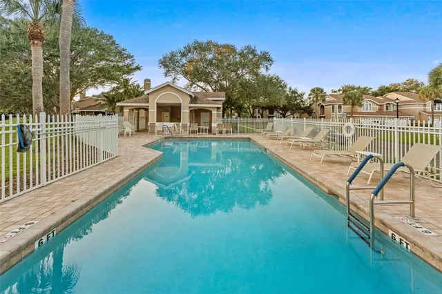 a view of a house with pool and a yard