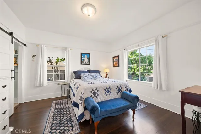 a bedroom with a bed a table and chair