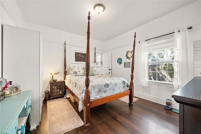 a bed room with a bed window and a wooden floor
