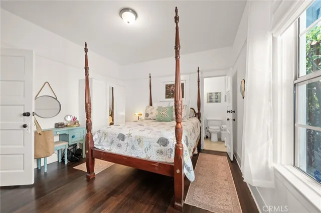 a bed room with a bed and a window