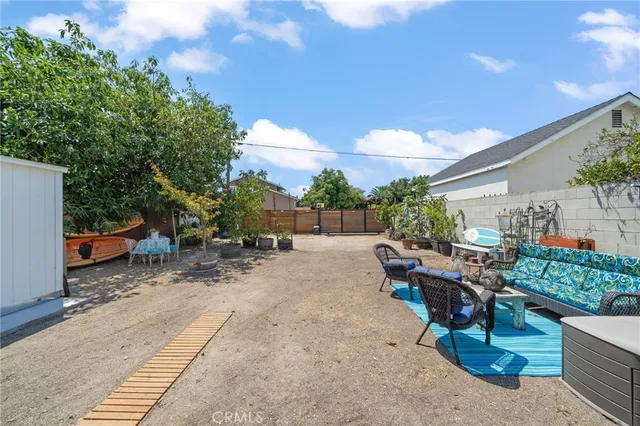 a view of a backyard with sitting area