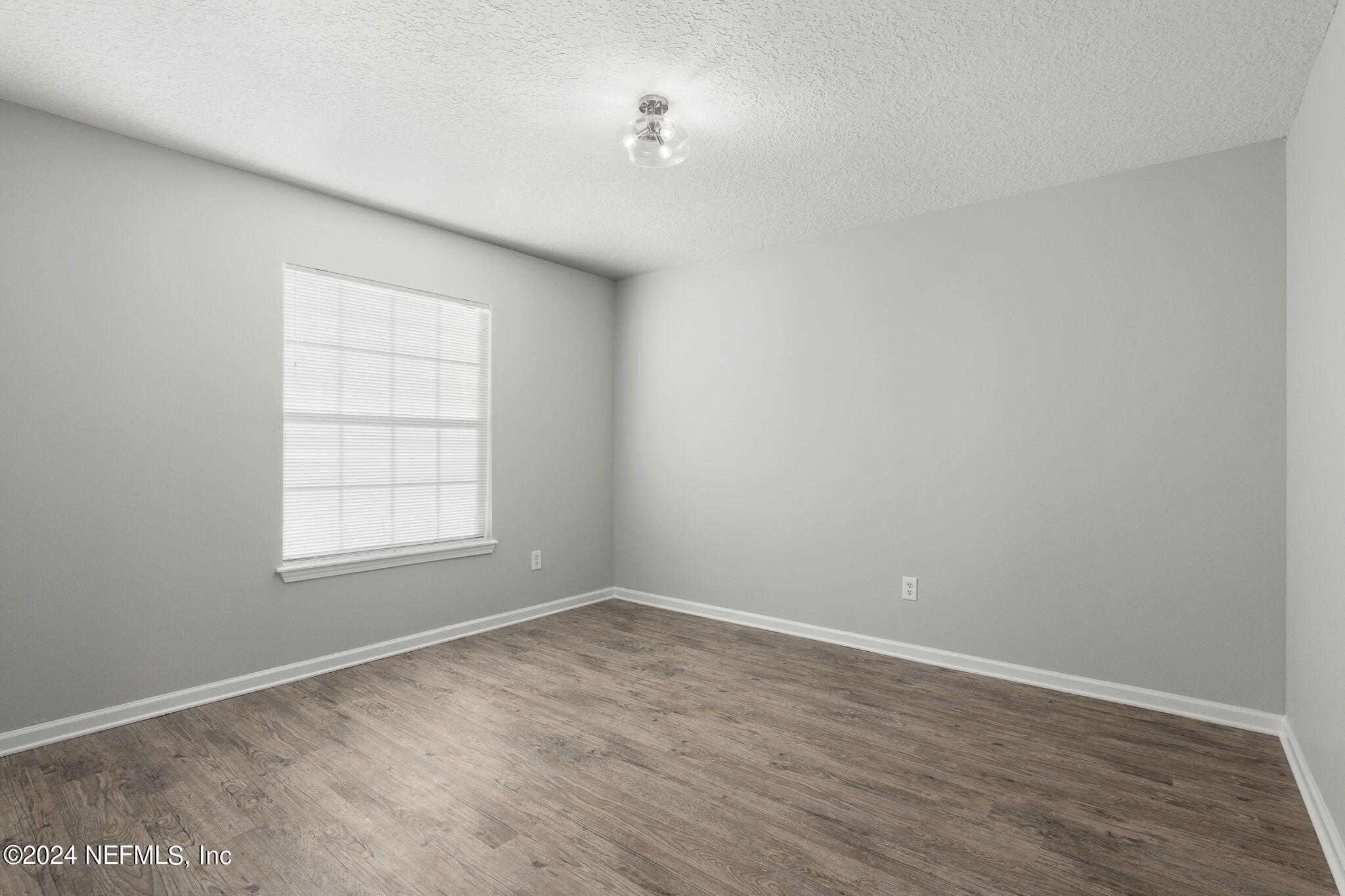 1579 Timber Trace Drive St. Augustine, FL 32092 - Photo 14 of 30 an empty room with wooden floor and windows