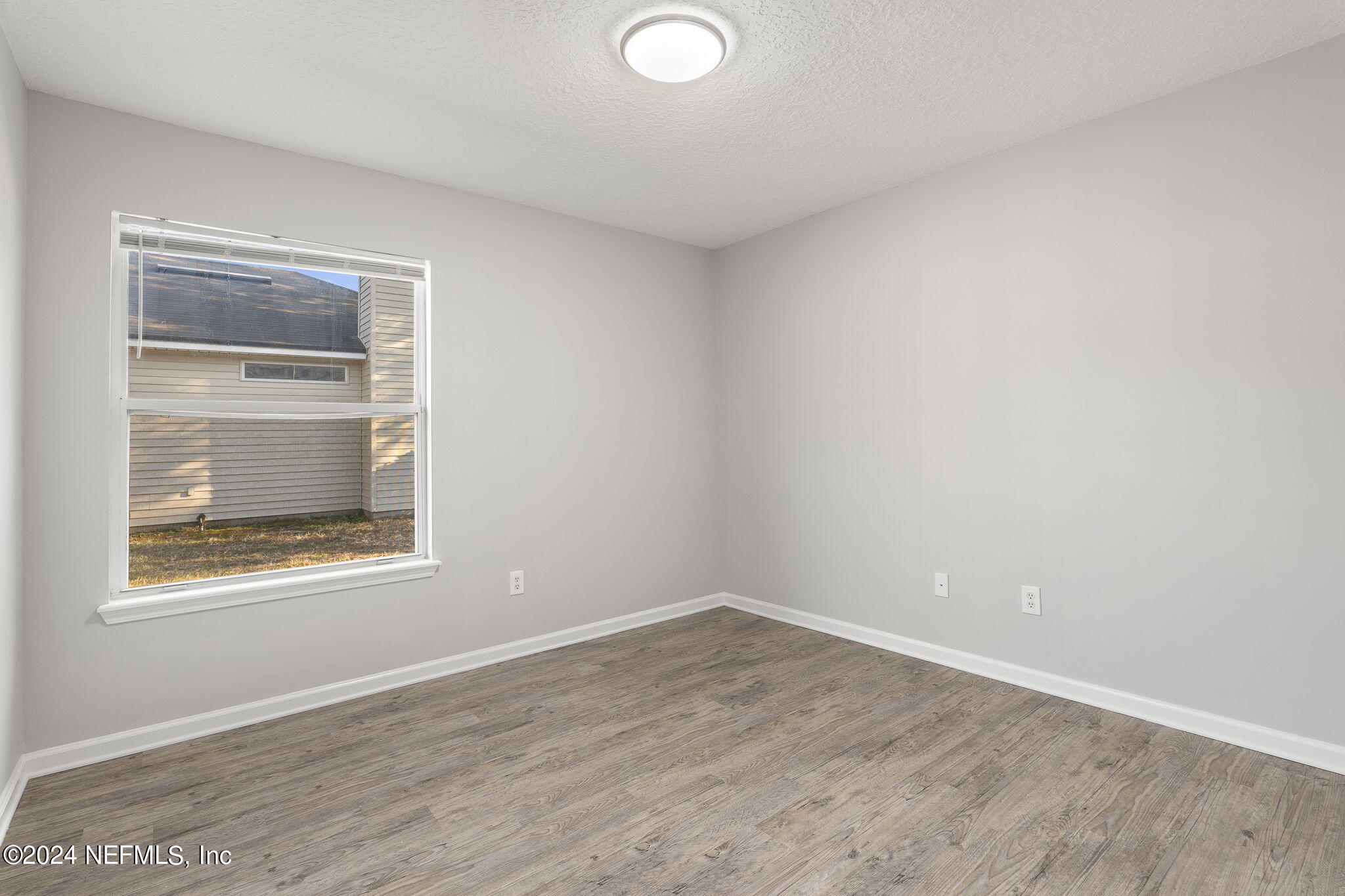 1579 Timber Trace Drive St. Augustine, FL 32092 - Photo 20 of 30 a view of an empty room with wooden floor and a window