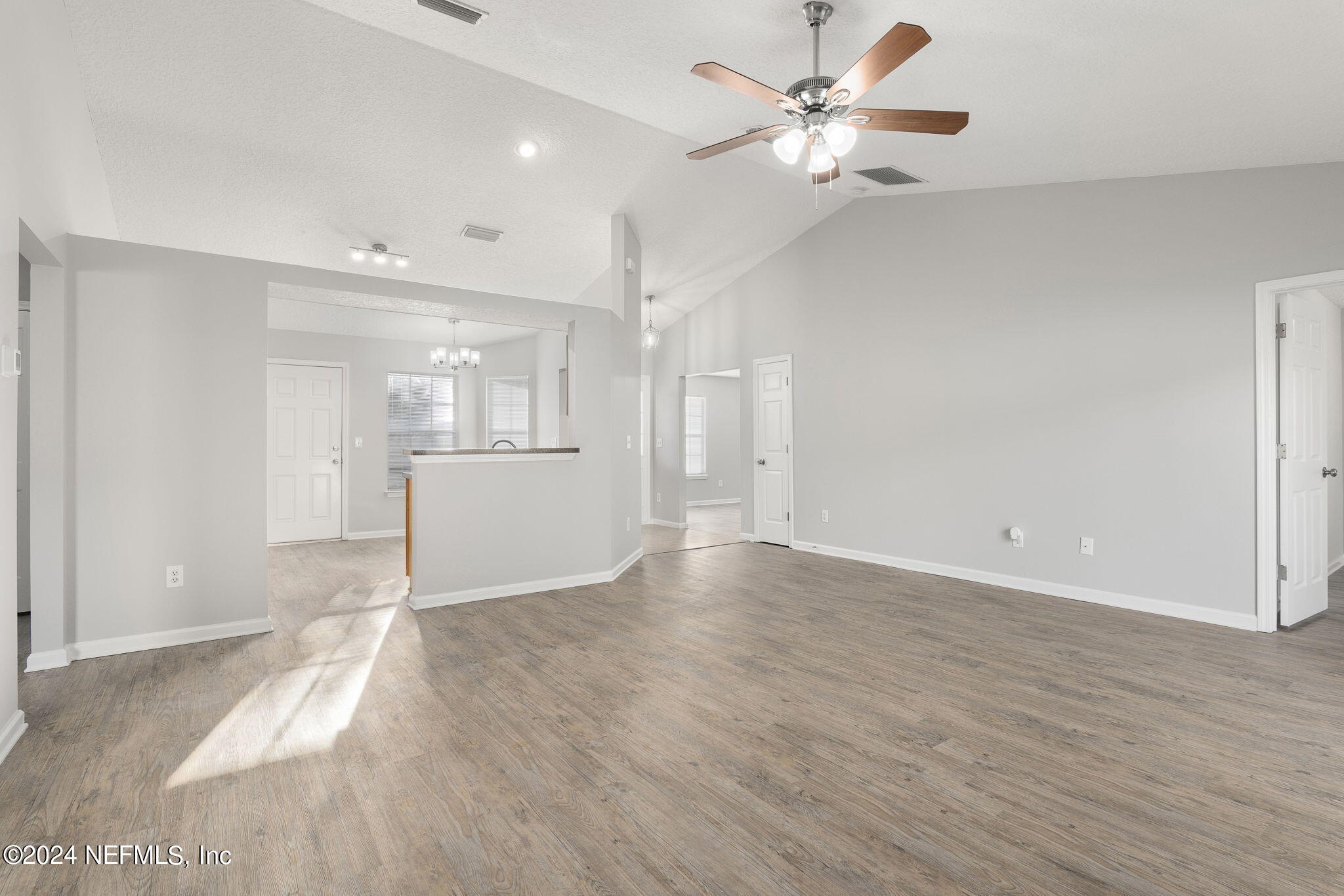 1579 Timber Trace Drive St. Augustine, FL 32092 - Photo 4 of 30 a view of a big room with wooden floor and a ceiling fan