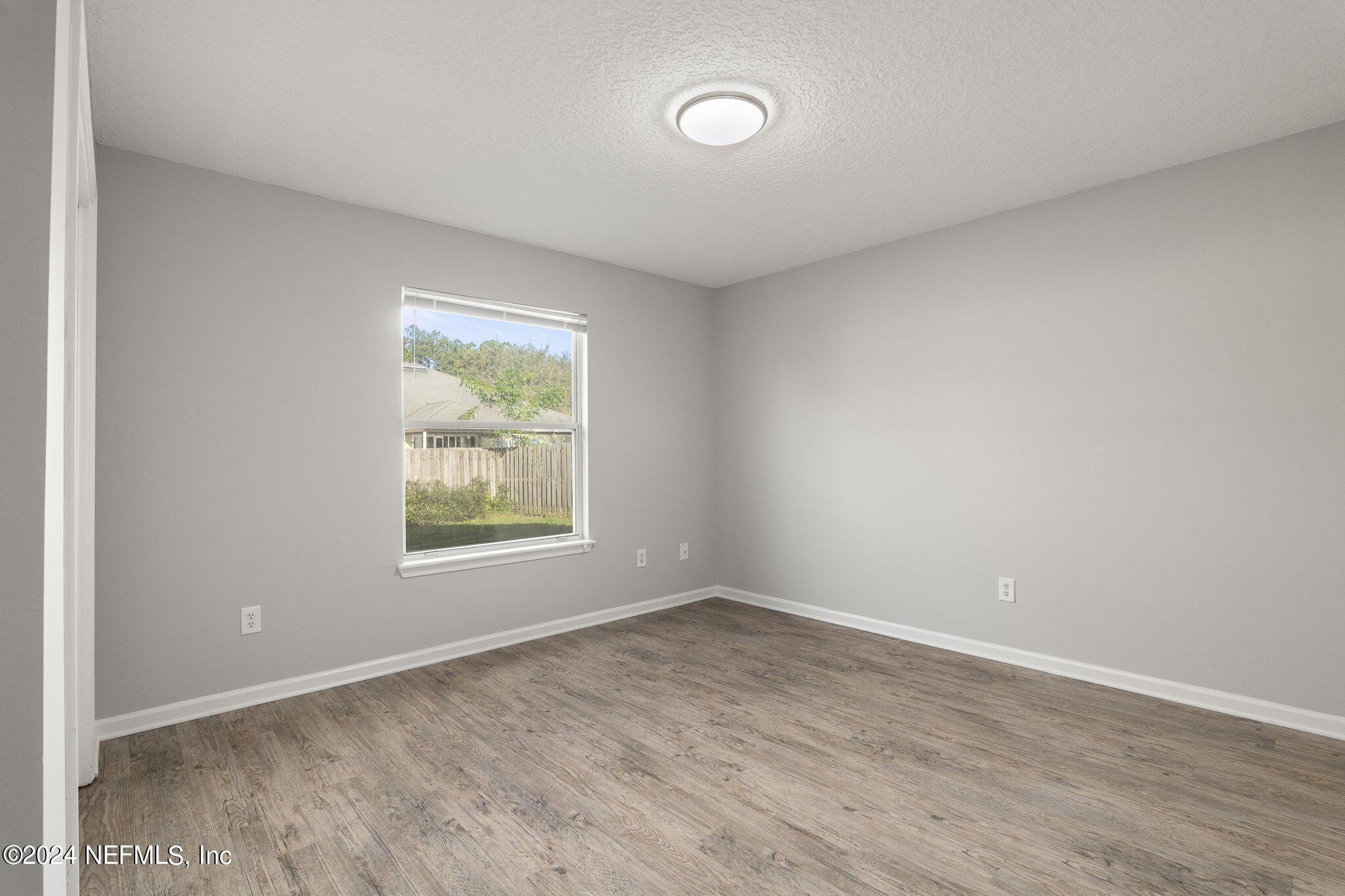1579 Timber Trace Drive St. Augustine, FL 32092 - Photo 9 of 30 wooden floor in an empty room with a window