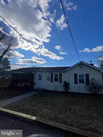a view of house with backyard and garden