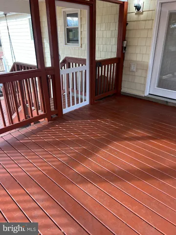 an empty room with windows and fireplace