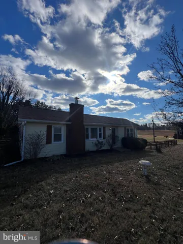 a view of house with yard
