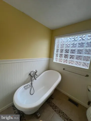 a view of a room with wooden floor and a window