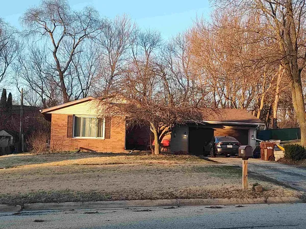 a view of a house with a yard covered in snow