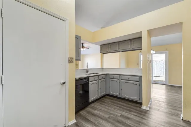 a kitchen with a sink cabinets stainless steel appliances and a window