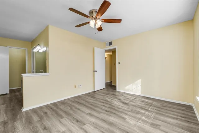 a view of an empty room and wooden floor