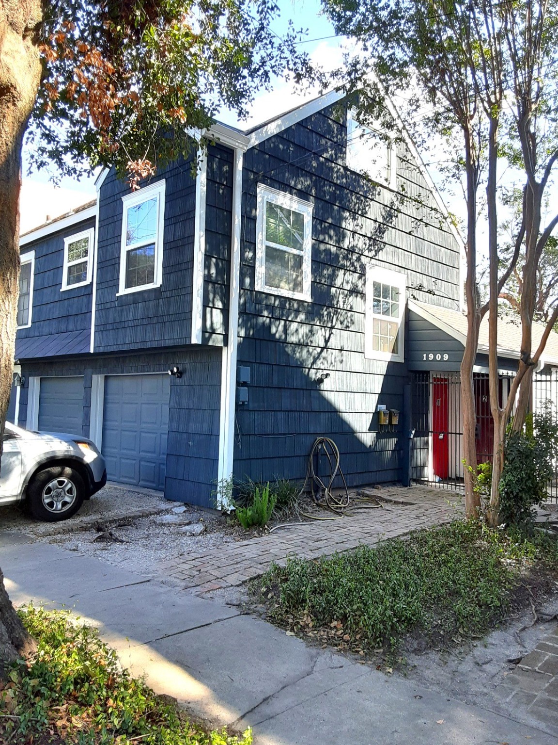 a view of a house with a yard and sitting area