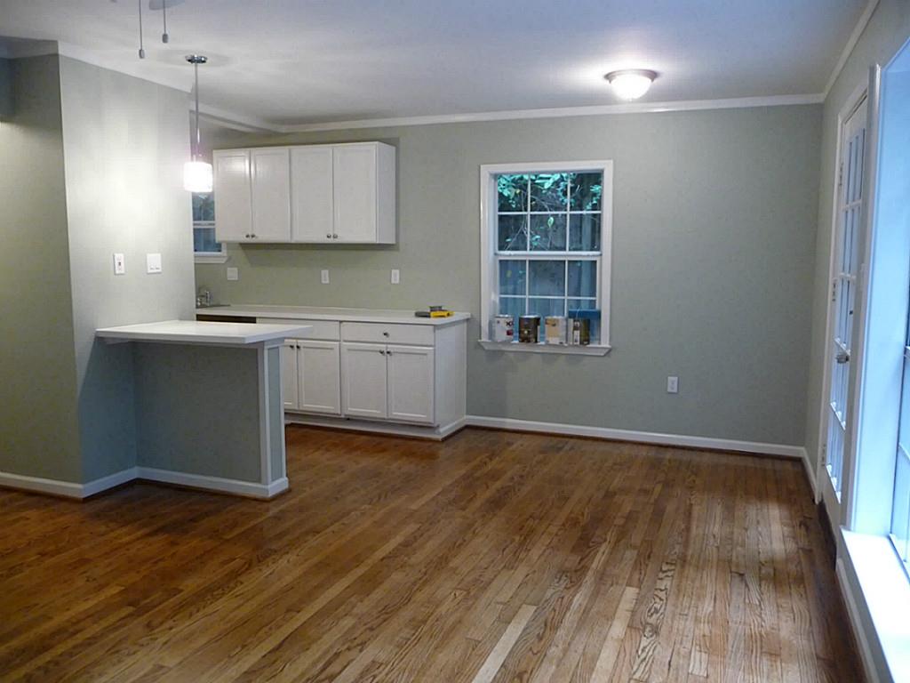 1909 Fairview Street, Unit 2 Houston, TX 77019 - Photo 4 of 10 a kitchen with granite countertop a stove and a wooden floors