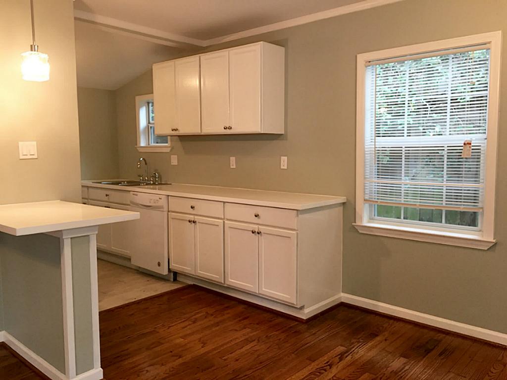 1909 Fairview Street, Unit 2 Houston, TX 77019 - Photo 5 of 10 a kitchen with a sink cabinets and wooden floor