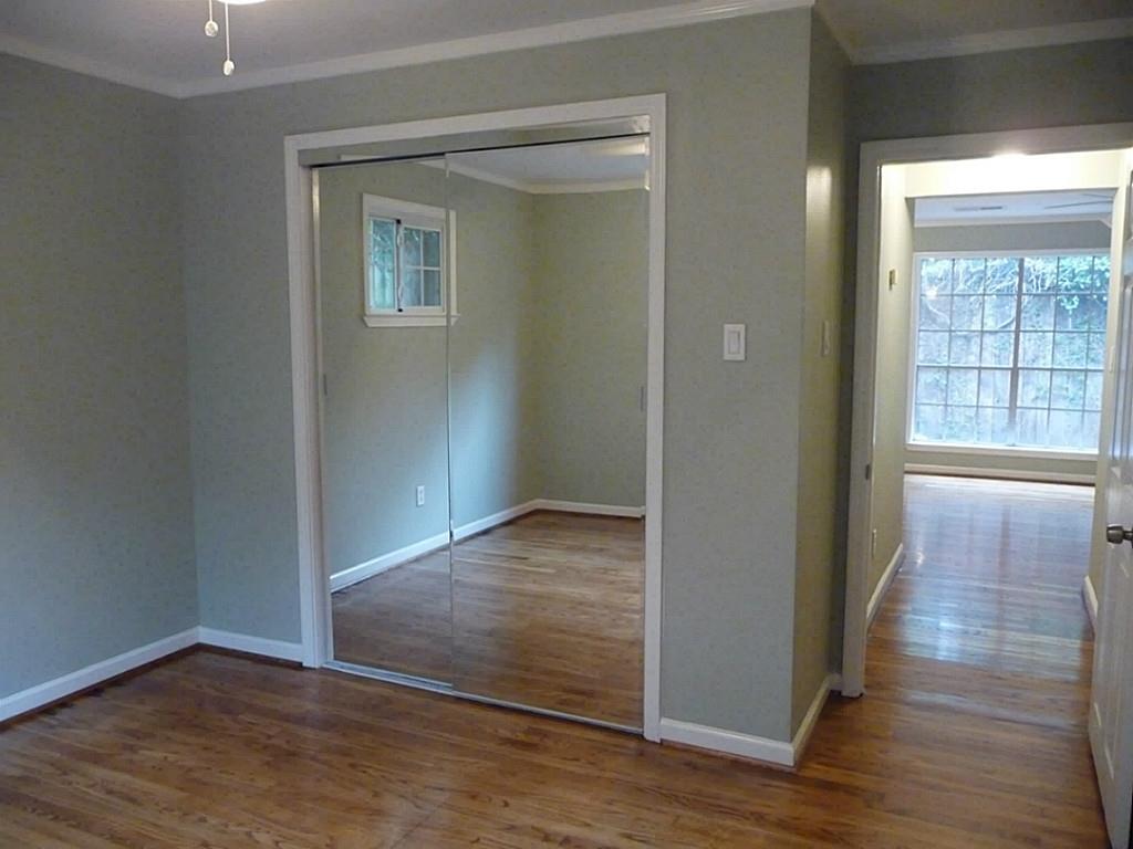 1909 Fairview Street, Unit 2 Houston, TX 77019 - Photo 9 of 10 an empty room with wooden floor and windows