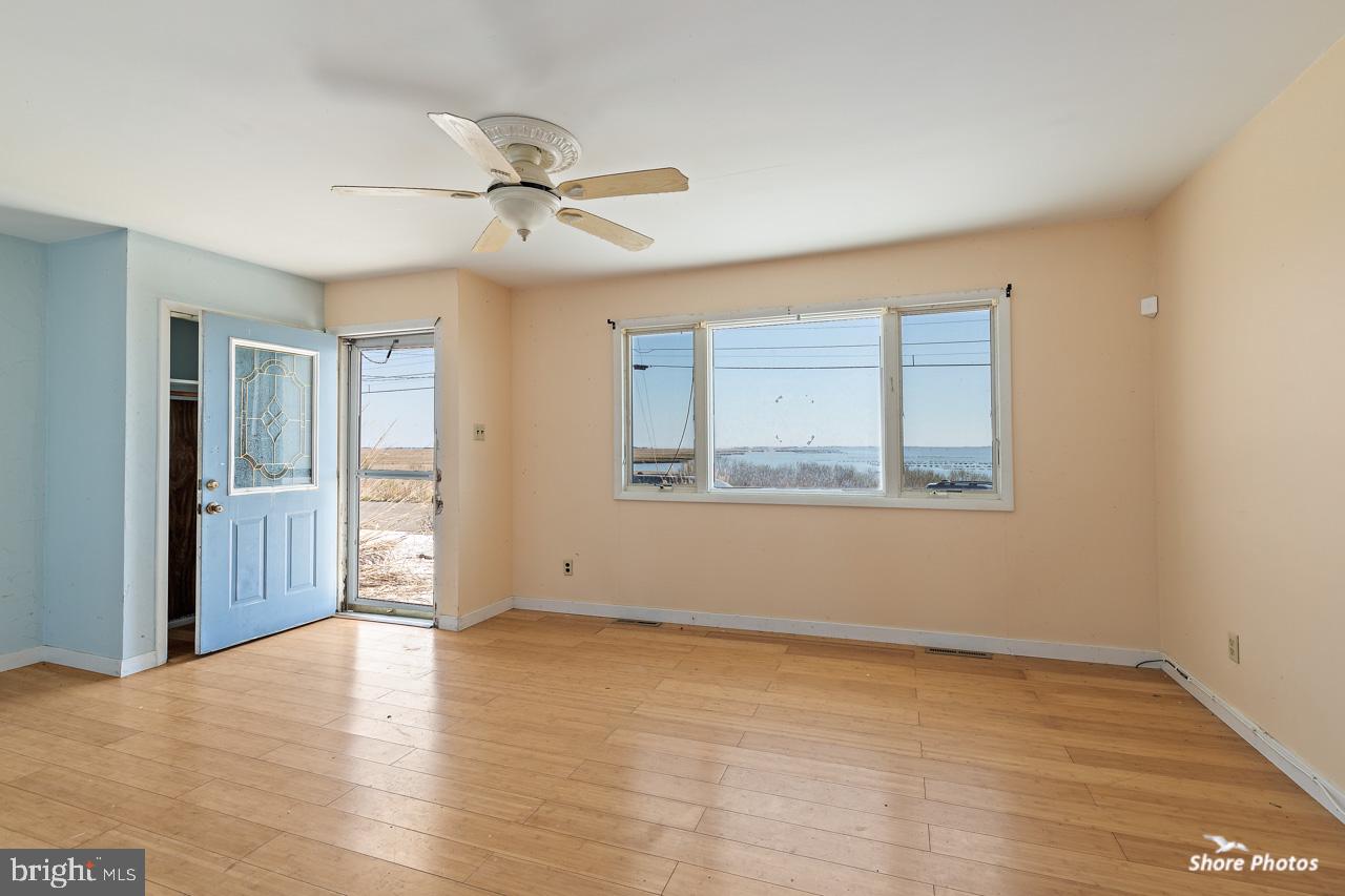 10 Iowa Court Tuckerton, NJ 08087 - Photo 17 of 33 an empty room with wooden floor ceiling fan and windows