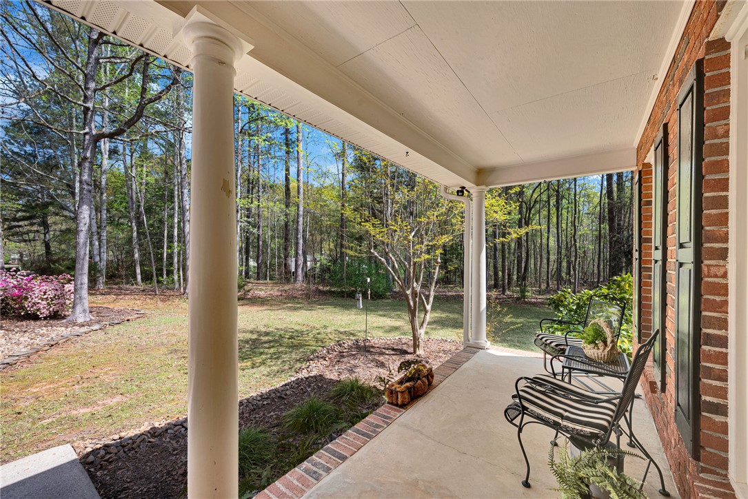 1010 Ridgeview Drive Pendleton, SC 29670 - Photo 6 of 47 Enjoy tranquil woodland views from this inviting front porch, perfect for peaceful mornings and relaxing evenings.