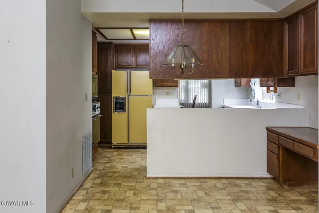 a kitchen with a refrigerator and a cabinets
