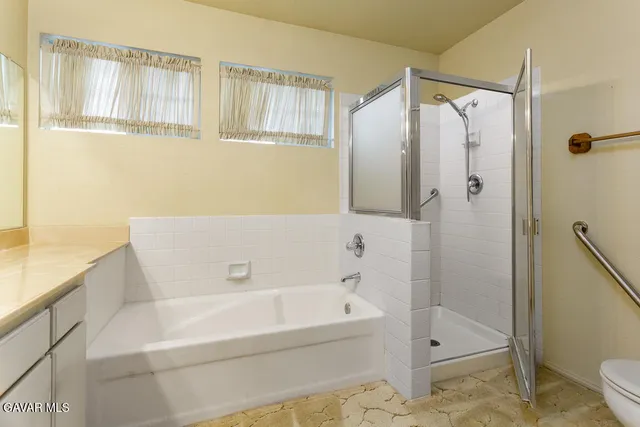 a bathroom with a bathtub and a shower